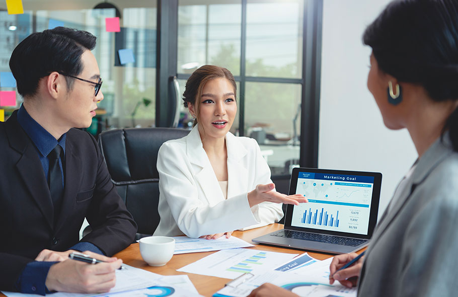 Team discussing OEM office furniture finish samples and specifications